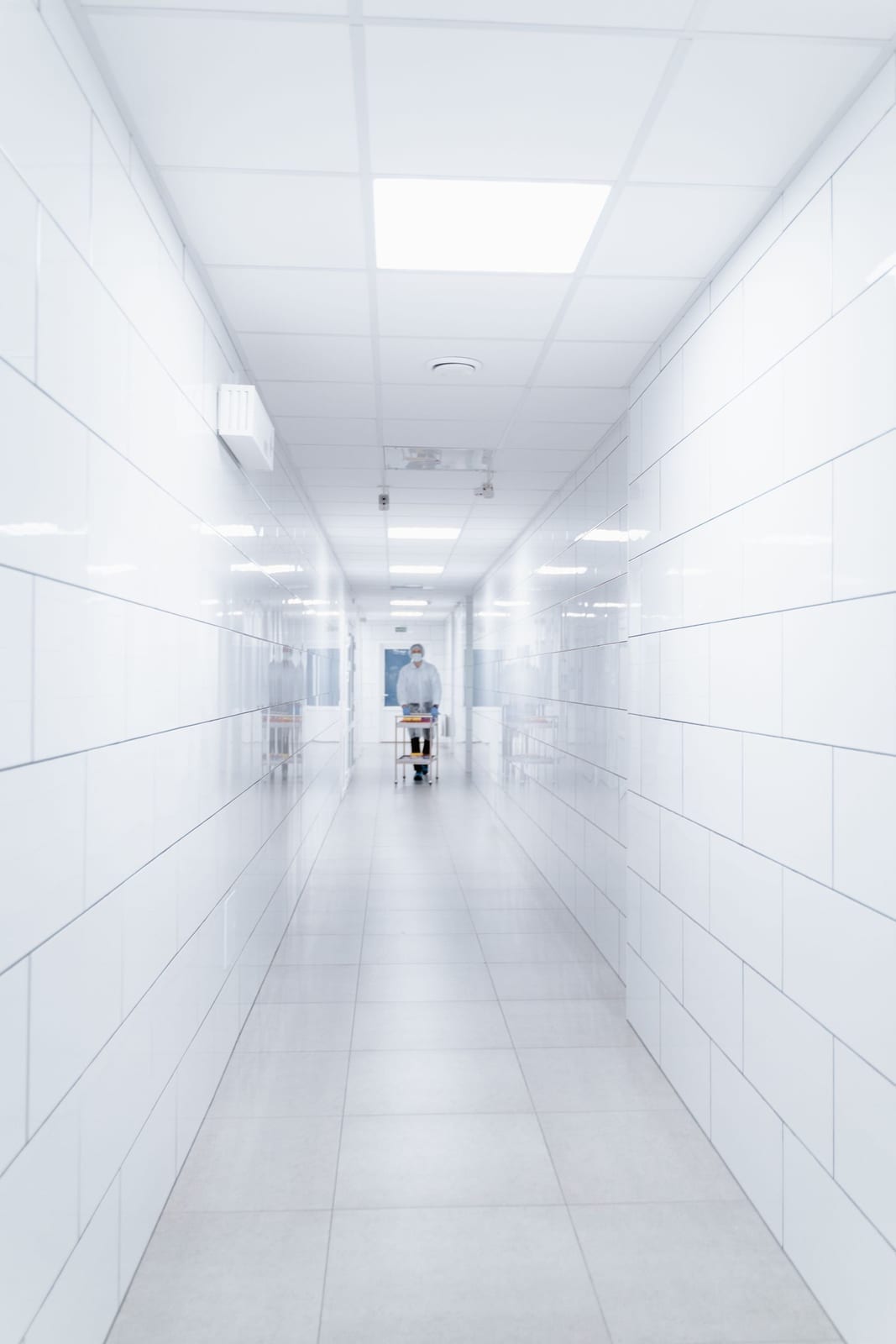 A medical professional walking through a hospital hallway