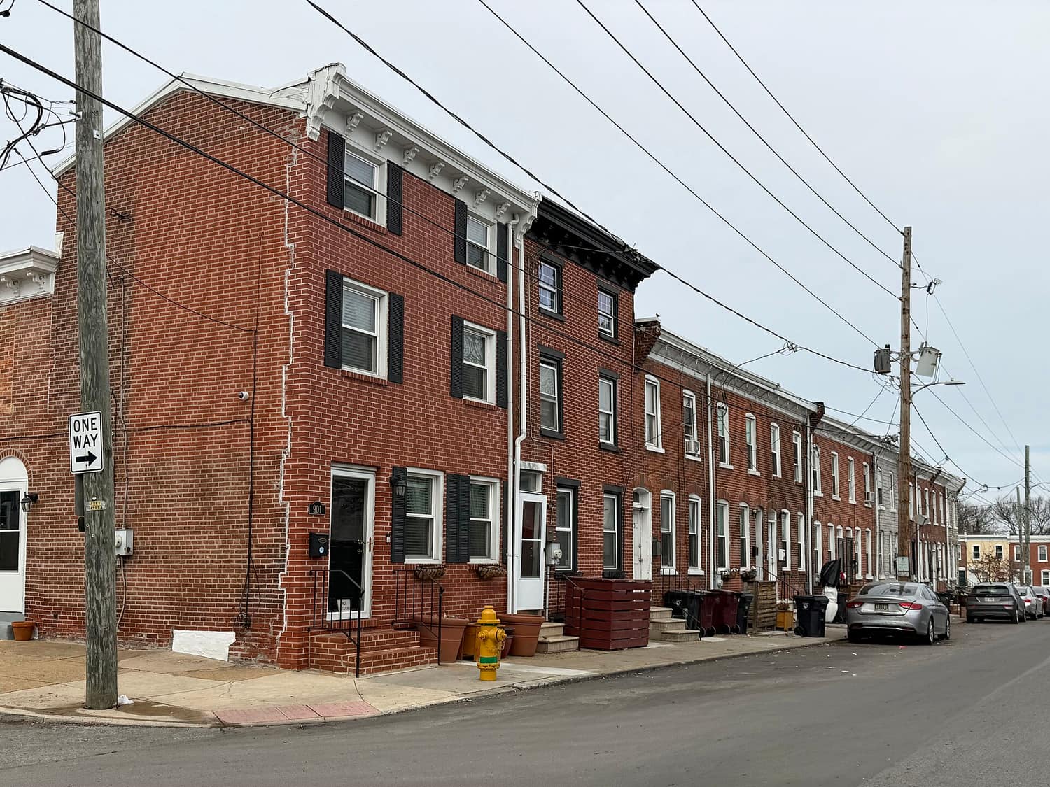 A terrace of historic brick rowhouses with white trim along Church Street in Wilmington, Delaware