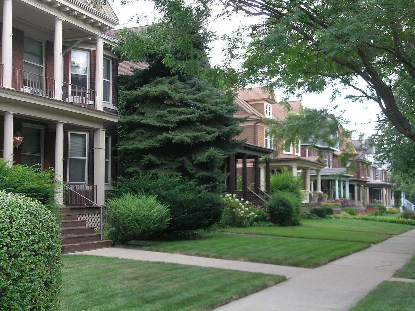 A residential street of houses with porches in the Woodbridge neighborhood of Detroit, Michigan