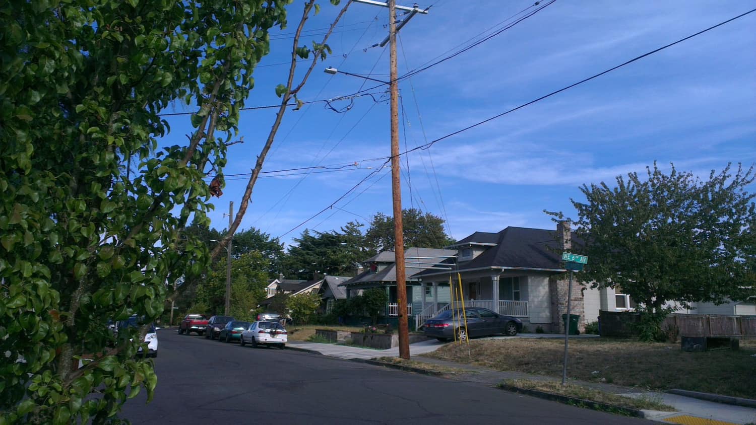 Modest wood-framed houses on a residential corner at NE 6th Avenue and Jarrett Street in Portland, Oregon